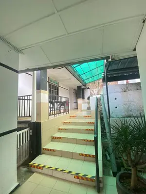 a hallway with stairs in a building with a plant at Darulmakmur Chalet in Cameron Highlands