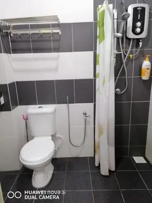 a bathroom with a toilet and a shower at alyaleesya homestay Teres in Brinchang