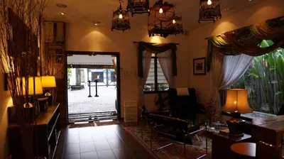 a living room with a door open to a yard at Kinta Bali Villa in Ipoh