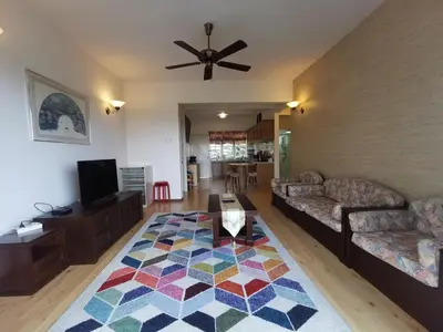 a living room with a couch and a table at Little England B8 in Bukit Fraser