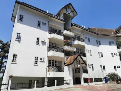 a large white building with black balconies at Little England B8 in Bukit Fraser