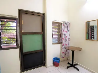 a room with a table and a glass door at Star Lodge in George Town