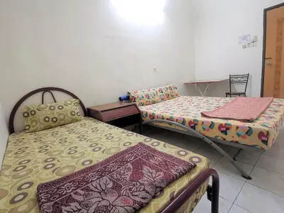 a room with two beds and a table at Star Lodge in George Town