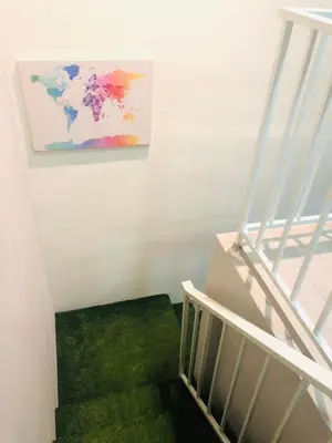 a staircase with a painting of a world on the wall at Seri Manjung HomeStay @Spacious Family Home in Seri Manjung