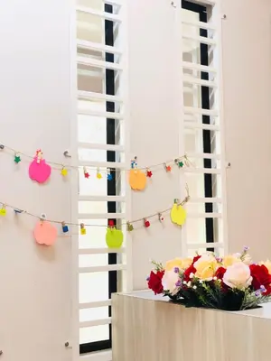a table with flowers and a string of lights at Seri Manjung HomeStay @Spacious Family Home in Seri Manjung