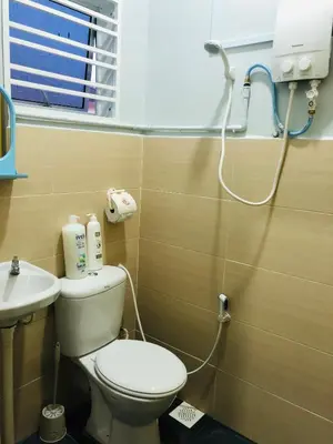 a bathroom with a toilet and a sink at Seri Manjung HomeStay @Spacious Family Home in Seri Manjung