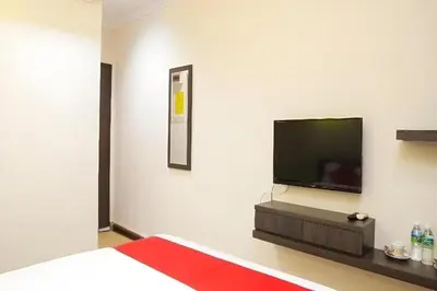 a bedroom with a flat screen tv on a wall at T P Hotel in Sitiawan