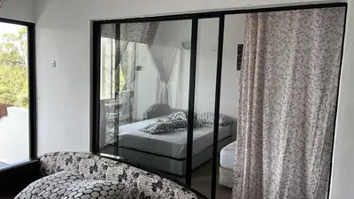 a bedroom with a bed and a window at Silverpark Resort C2-5-1 or C3-3A-2 walk up in Bukit Fraser