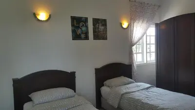 a bedroom with two beds and a window at Silverpark Resort C2-5-1 or C3-3A-2 walk up in Bukit Fraser
