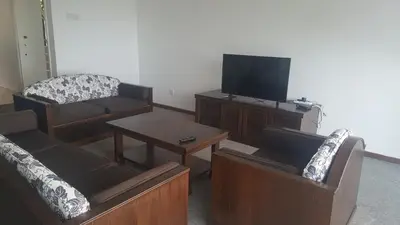 a living room with two couches and a flat screen tv at Silverpark Resort C2-5-1 or C3-3A-2 walk up in Bukit Fraser