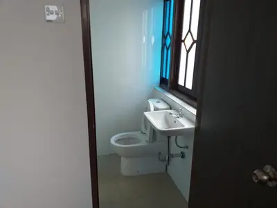 a bathroom with a toilet and a sink and a window at Hotel Peking in Taiping