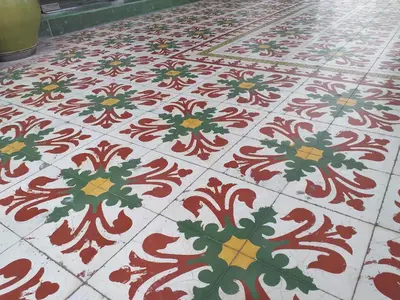 a red and white tile floor with a cross on it at Hotel Peking in Taiping