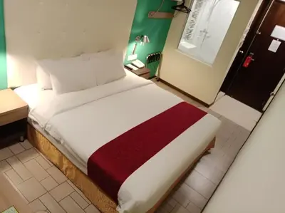 a hotel room with a large bed in a room at Ritz Suites in Lumut