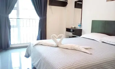 a swan made out of towels sitting on a bed at Hotel Pangkor SJ in Pangkor