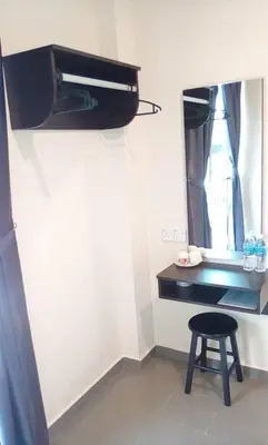 a small room with a stool and a mirror at Hotel Pangkor SJ in Pangkor