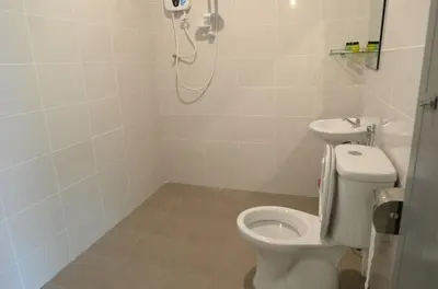 a bathroom with a white toilet and a shower at Hotel Pangkor SJ in Pangkor