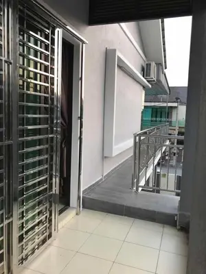 an open door of a building with a balcony at Family Homestay in Taiping