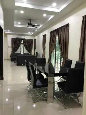 a living room with a table and chairs in it at Family Homestay in Taiping