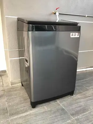a small stainless steel refrigerator in a kitchen at Family Homestay in Taiping