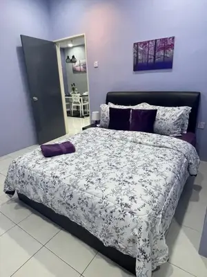 a bedroom with a large bed with purple walls at Cameron Lavender Homestay in Cameron Highlands