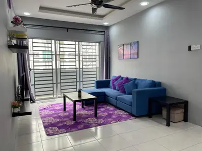 a living room with a blue couch and a table at Cameron Lavender Homestay in Cameron Highlands