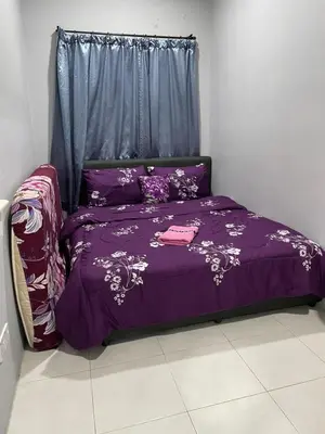 a purple bed in a room with a window at Cameron Lavender Homestay in Cameron Highlands