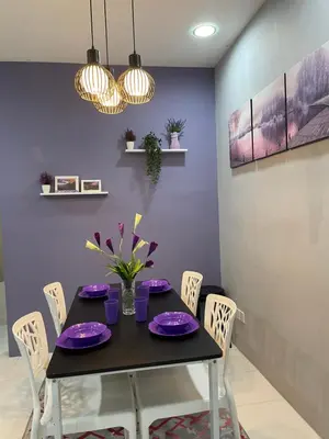 a dining room with a black table and chairs at Cameron Lavender Homestay in Cameron Highlands