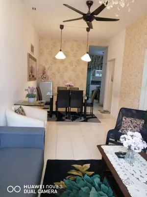 a living room with a couch and a table at Alyaleesya Muslim Homestay in Tanah Rata