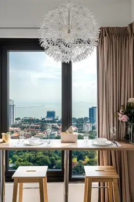 a chandelier hanging over a table with a large window at Tropicana 218 Macalister by Simply Penang in George Town