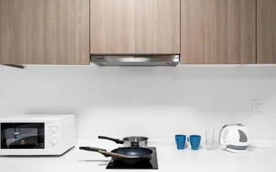 a kitchen counter with a microwave and a pot on a stove at Tropicana 218 Macalister by Simply Penang in George Town