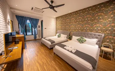 a bedroom with two beds and a couch and a tv at Carnarvon Suites in George Town