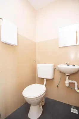 a bathroom with a toilet and a sink at Hotel O Hajah Rohayah in Tanjung Malim