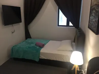 a small bedroom with a bed and a window at COMFORTABLE STAY in Ayer Itam