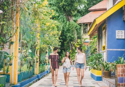 three women walking down a street in auriuri resort at Lost Paradise Resort in Batu Ferringhi