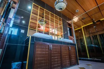 a bathroom with two sinks and a wooden door at Lost Paradise Resort in Batu Ferringhi