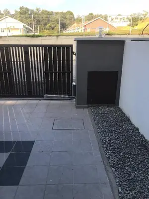 a building with a gate and a patio at Ipoh Water Front City Homestay in Ipoh