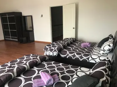 a living room with a bed and a couch at Ipoh Water Front City Homestay in Ipoh