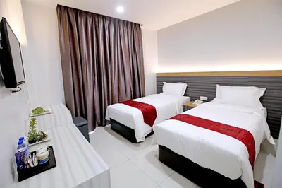 a hotel room with two beds and a television at B&L HOTEl in Sungkai