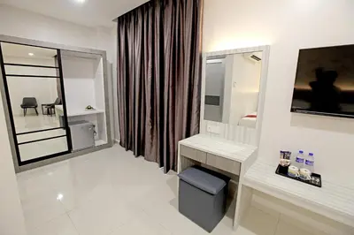 a white bathroom with a sink and a mirror at B&L HOTEl in Sungkai