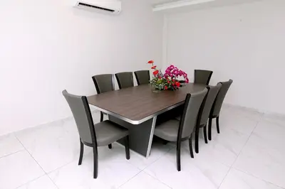 a dining room table and chairs with flowers on it at B&L HOTEl in Sungkai