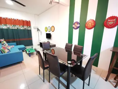 a living room with a table and chairs and a couch at The Woodz Homestay - 2 Storey Landed House in Cameron Highlands