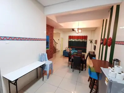 a dining room and living room with a table and chairs at The Woodz Homestay - 2 Storey Landed House in Cameron Highlands