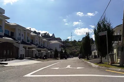 an empty street in a residential neighborhood with houses at The Woodz Homestay - 2 Storey Landed House in Cameron Highlands
