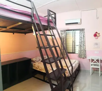 a bunk bed in a room with a ladder at Hua Tang Homestay in Ipoh