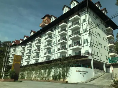 a large white building with a clock on top at EagleNest at Iris House Resort in Tanah Rata