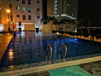 a swimming pool at night in a city at Strait Garden Studio X Ace Pro @ George Town in George Town