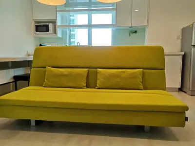 a green couch with two pillows sitting in a kitchen at Strait Garden Studio X Ace Pro @ George Town in George Town