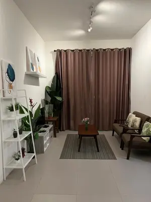 a living room with a couch and a table at Cahaya Gardens 2 rooms at Golden Hills depan pasar malam in Brinchang