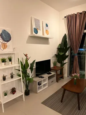 a living room with a flat screen tv and a table at Cahaya Gardens 2 rooms at Golden Hills depan pasar malam in Brinchang