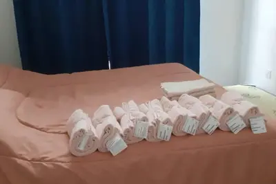 a group of white towels on a bed at Cahaya Gardens 2 rooms at Golden Hills depan pasar malam in Brinchang